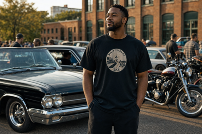Man wearing the black LKS Built in the Community heavyweight tee at a car meet